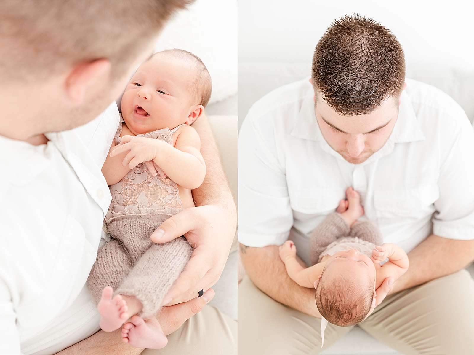 lifestyle newborn session of dad holding baby cradled in his arms while baby smile up at dad and dad sitting on light grey couch holding baby out in front of him looking down at his baby girl wearing a white shirt and tan pants newborn wearing light brown halter lace overalls