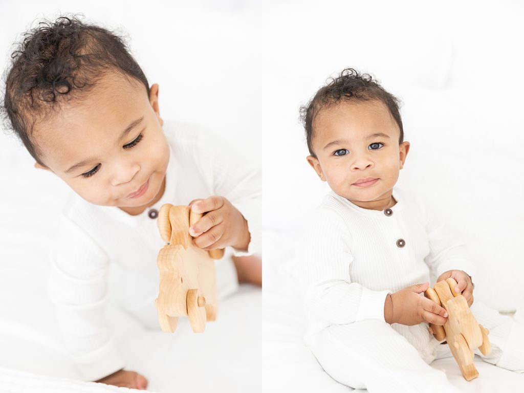 one year old boy playing with wooden dog toy at lifestyle family session
