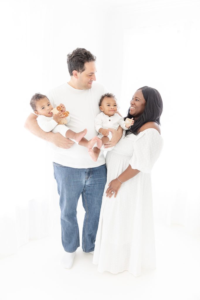 Sweet mixed race family of four with beautiful twin boys